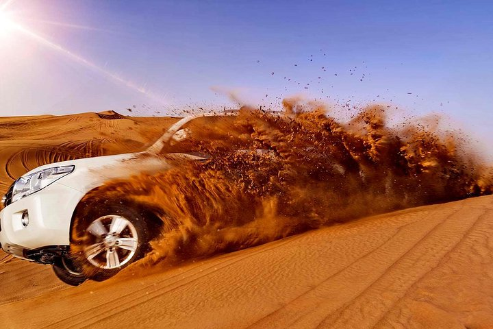 Experience the unique drive across expansive dunes in a LandCruiser capturing stunning sunset views while exploring the vast Dubai desert. Perfect for adventure seekers and nature lovers alike.